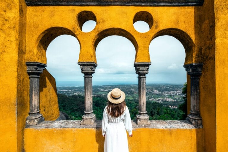 Traveler woman visiting Pena Palace in Sintra, Lisbon, Portugal. Famous landmark